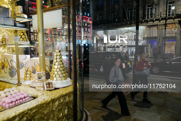 People walk past the Burlington Arcade in Mayfair, London, on November 7, 2024. 