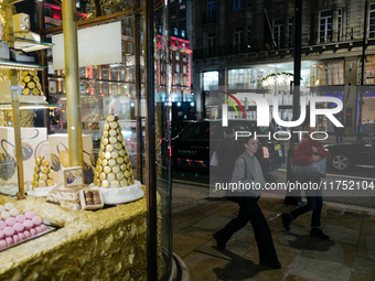 People walk past the Burlington Arcade in Mayfair, London, on November 7, 2024. (