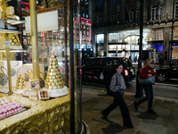 People walk past the Burlington Arcade in Mayfair, London, on November 7, 2024. (