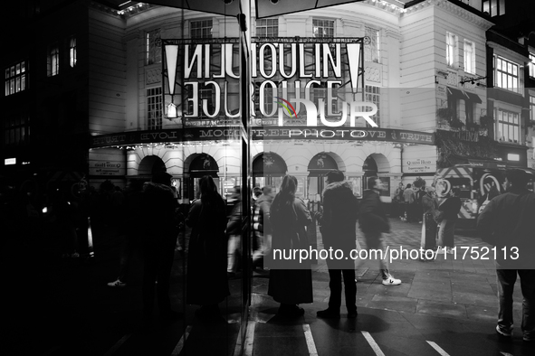 The Piccadilly Theatre reflects in a glass window in London, England, on November 7, 2024. 