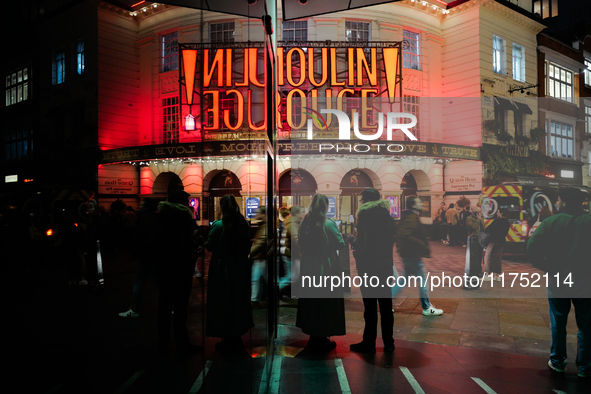 The Piccadilly Theatre reflects in a glass window in London, England, on November 7, 2024. 