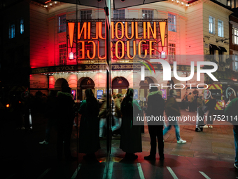 The Piccadilly Theatre reflects in a glass window in London, England, on November 7, 2024. (