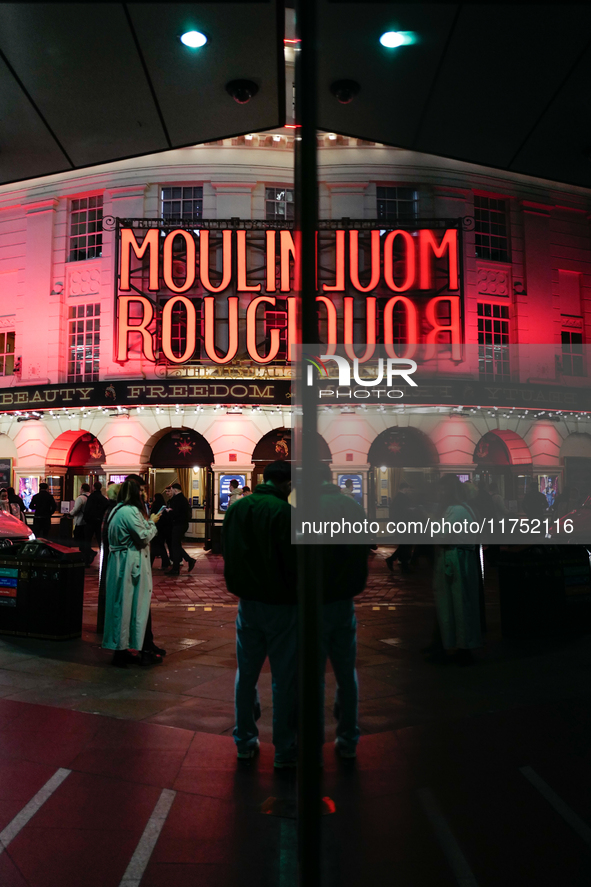 The Piccadilly Theatre reflects in a glass window in London, England, on November 7, 2024. 