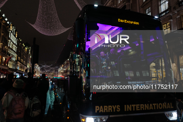 A passenger sits on a coach as it drives on Regent Street in London, England, on November 7, 2024. 