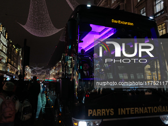 A passenger sits on a coach as it drives on Regent Street in London, England, on November 7, 2024. (