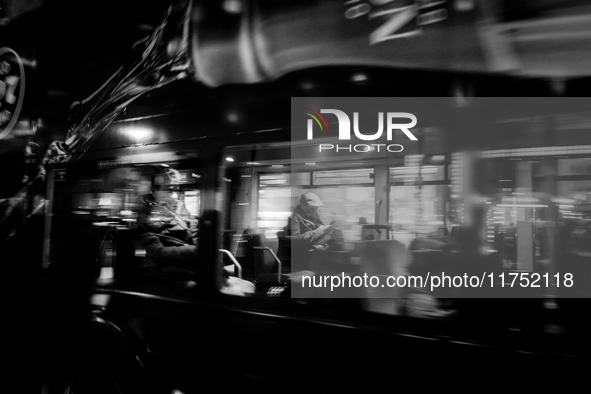 A man sits on a bus as it drives on Regent Street in London, United Kingdom, on November 7, 2024. 