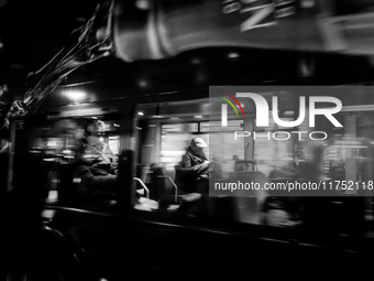 A man sits on a bus as it drives on Regent Street in London, United Kingdom, on November 7, 2024. (