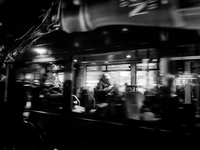 A man sits on a bus as it drives on Regent Street in London, United Kingdom, on November 7, 2024. (