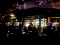 A man sits on a bus as it drives on Regent Street in London, United Kingdom, on November 7, 2024. (