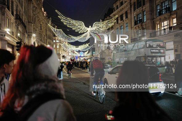 People take photos of the Christmas lights in Regent Street, London, on November 7, 2024. 