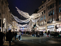 People take photos of the Christmas lights in Regent Street, London, on November 7, 2024. (