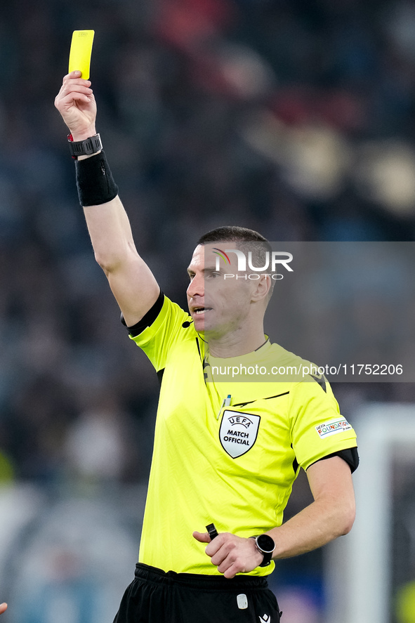 Referee Georgi Kabakov shows a yellow card during the UEFA Europa League 2024/25 League Phase MD4 match between SS Lazio and FC Porto at Sta...