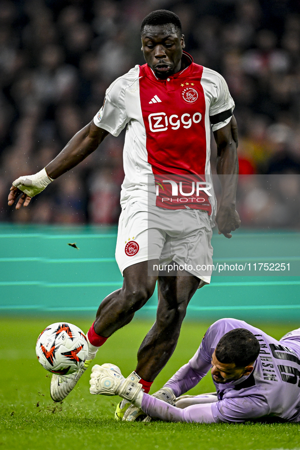 AFC Ajax Amsterdam forward Brian Brobbey and Maccabi Tel Aviv goalkeeper Roi Mishpati play during the match between Ajax and Maccabi Tel Avi...