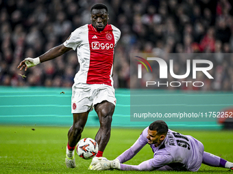 AFC Ajax Amsterdam forward Brian Brobbey and Maccabi Tel Aviv goalkeeper Roi Mishpati play during the match between Ajax and Maccabi Tel Avi...