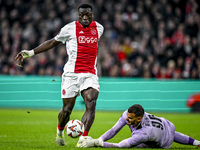 AFC Ajax Amsterdam forward Brian Brobbey and Maccabi Tel Aviv goalkeeper Roi Mishpati play during the match between Ajax and Maccabi Tel Avi...