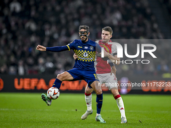 Maccabi Tel Aviv midfielder Sagiv Jehezkel and AFC Ajax Amsterdam defender Anton Gaaei play during the match between Ajax and Maccabi Tel Av...