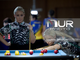 Twin sisters Carrie and Megan Randle from the Blackball Federation of Ireland national ladies doubles team perform during a doubles ladies e...