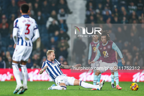 #20, Uros Racic of WBA gets his toe to the ball to deny #30, Luca Koleosho of Burnley possession during the Sky Bet Championship match betwe...