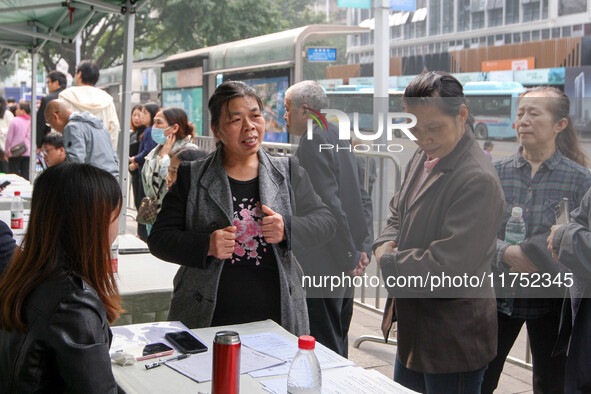 Job seekers learn about employment at a job fair in Chongqing, China, on November 7, 2024. 