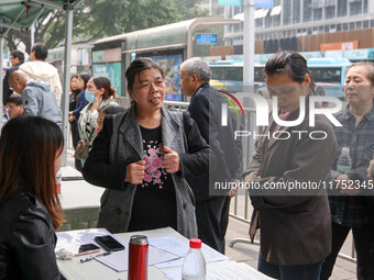 Job seekers learn about employment at a job fair in Chongqing, China, on November 7, 2024. (