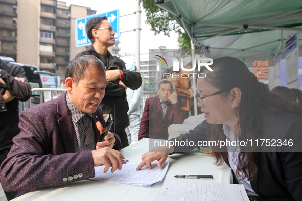 Job seekers learn about employment at a job fair in Chongqing, China, on November 7, 2024. 