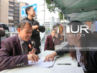 Job seekers learn about employment at a job fair in Chongqing, China, on November 7, 2024. (