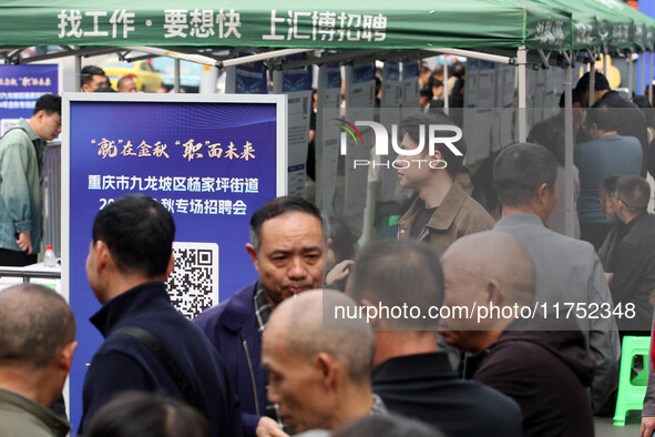 Job seekers learn about employment at a job fair in Chongqing, China, on November 7, 2024. 