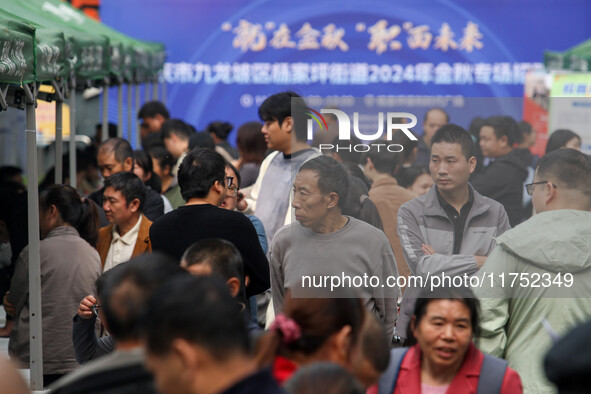 Job seekers learn about employment at a job fair in Chongqing, China, on November 7, 2024. 