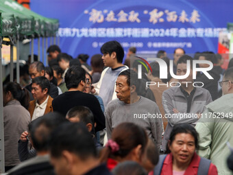 Job seekers learn about employment at a job fair in Chongqing, China, on November 7, 2024. (