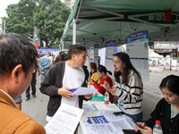 Job seekers learn about employment at a job fair in Chongqing, China, on November 7, 2024. (