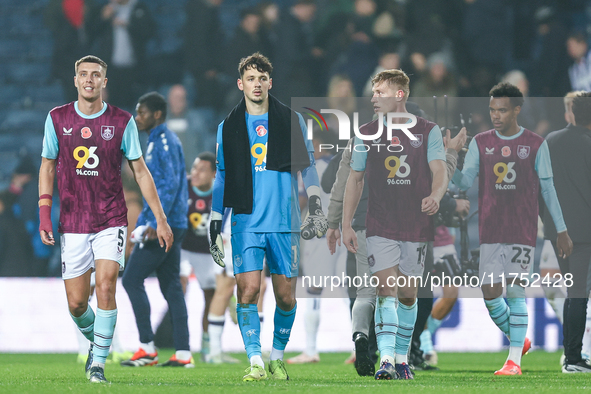 Maxime Esteve (#5), James Trafford (#1), and Zian Flemming (#19) of Burnley pose post-match during the Sky Bet Championship match between We...