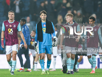 Maxime Esteve (#5), James Trafford (#1), and Zian Flemming (#19) of Burnley pose post-match during the Sky Bet Championship match between We...