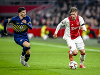 Maccabi Tel Aviv forward Dor Turgeman and AFC Ajax Amsterdam forward Mika Godts play during the match between Ajax and Maccabi Tel Aviv at t...