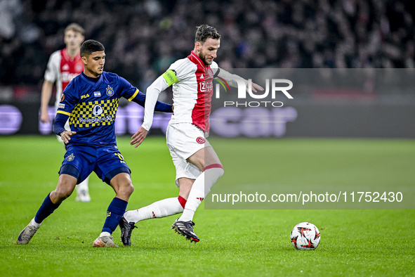 Maccabi Tel Aviv midfielder Sagiv Jehezkel and AFC Ajax Amsterdam midfielder Branco van den Boomen play during the match between Ajax and Ma...