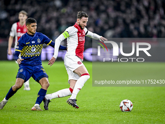 Maccabi Tel Aviv midfielder Sagiv Jehezkel and AFC Ajax Amsterdam midfielder Branco van den Boomen play during the match between Ajax and Ma...