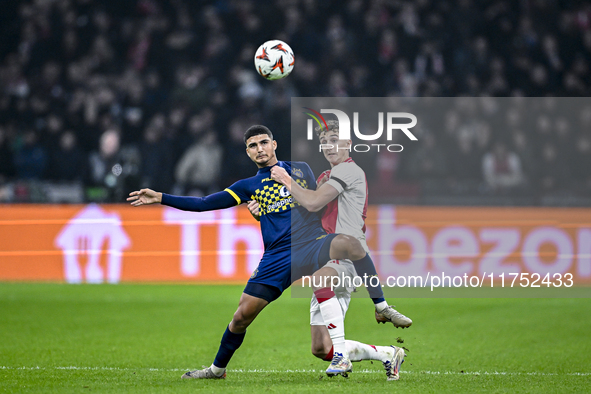 Maccabi Tel Aviv midfielder Elad Madmon and AFC Ajax Amsterdam defender Youri Baas play during the match between Ajax and Maccabi Tel Aviv a...