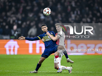 Maccabi Tel Aviv midfielder Elad Madmon and AFC Ajax Amsterdam defender Youri Baas play during the match between Ajax and Maccabi Tel Aviv a...