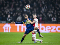 Maccabi Tel Aviv midfielder Elad Madmon and AFC Ajax Amsterdam defender Youri Baas play during the match between Ajax and Maccabi Tel Aviv a...