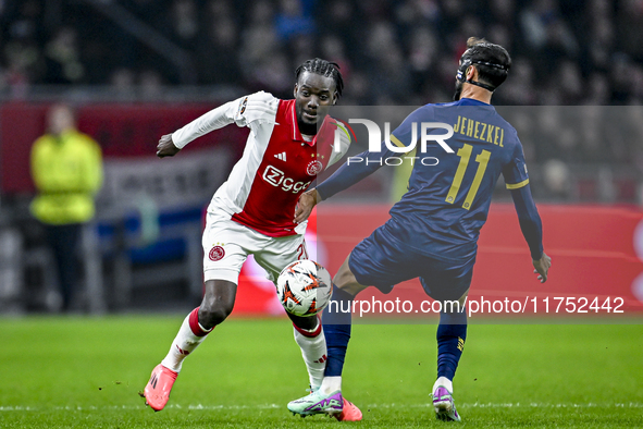 AFC Ajax Amsterdam forward Bertrand Traore and Maccabi Tel Aviv midfielder Sagiv Jehezkel play during the match between Ajax and Maccabi Tel...