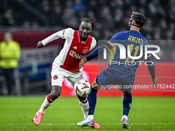 AFC Ajax Amsterdam forward Bertrand Traore and Maccabi Tel Aviv midfielder Sagiv Jehezkel play during the match between Ajax and Maccabi Tel...