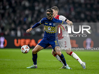 Maccabi Tel Aviv midfielder Sagiv Jehezkel and AFC Ajax Amsterdam defender Anton Gaaei play during the match between Ajax and Maccabi Tel Av...