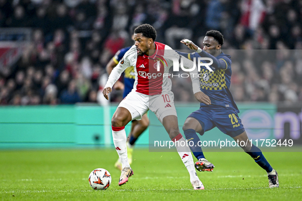 AFC Ajax Amsterdam forward Chuba Akpom and Maccabi Tel Aviv midfielder Issouf Sissokho play during the match between Ajax and Maccabi Tel Av...