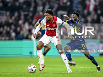 AFC Ajax Amsterdam forward Chuba Akpom and Maccabi Tel Aviv midfielder Issouf Sissokho play during the match between Ajax and Maccabi Tel Av...