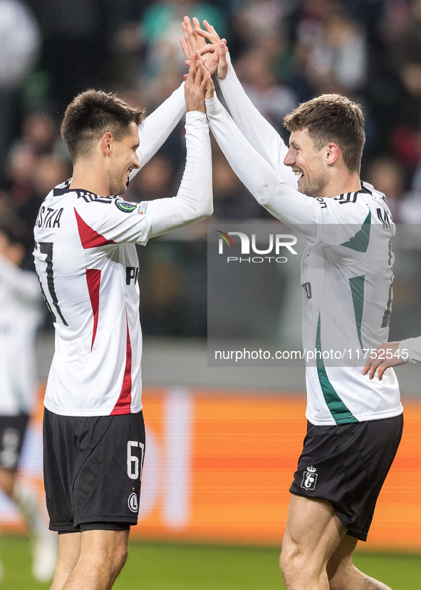 Bartosz Kapustka , Mark Gual , goal celebration during UEFA Conference League match Legia Warsaw vs Dinamo Minsk in Warsaw Poland on 7 Novem...