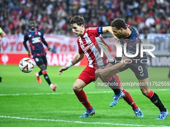 Panagiotis Retsos of Olympiacos FC competes with Cyriel Dessers of Rangers during the Europa League, Matchday 4 match between Olympiacos FC...