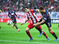 Panagiotis Retsos of Olympiacos FC competes with Cyriel Dessers of Rangers during the Europa League, Matchday 4 match between Olympiacos FC...