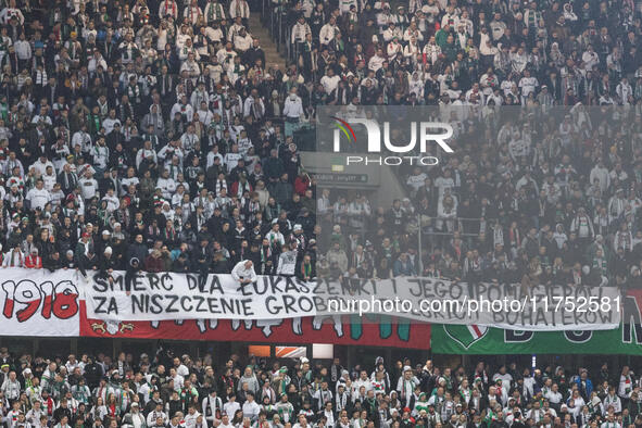 Legia fans present a banner insulting Aleksandr Lukashenko during UEFA Conference League match Legia Warsaw vs Dinamo Minsk in Warsaw Poland...