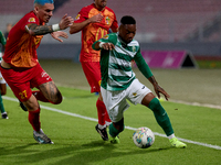 In Ta' Qali, Malta, on November 7, 2024, Kemar Reid of Floriana is closely followed by Alessandro Coppola of Birkirkara during the Malta 360...