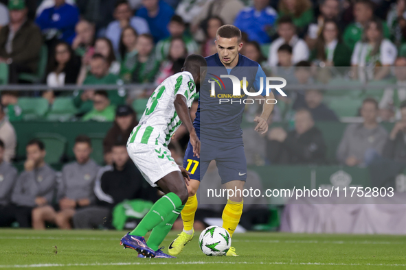 In Seville, Spain, on November 7, 2024, Ivan Brnic of NK Celje competes for the ball with Youssouf Sabaly of Real Betis during the UEFA Conf...