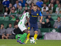 In Seville, Spain, on November 7, 2024, Ivan Brnic of NK Celje competes for the ball with Youssouf Sabaly of Real Betis during the UEFA Conf...